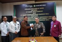 Direktur Utama Bank NTB Syariah Nazaruddin dan Direktur Kredit BPD Bali Made Lestara Widiatmika menandatangani kerja sama pelimpahan pembiayaan PNS di Denpasar. (Dok. Bank NTB Syariah)