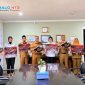 Jajaran pejabat dan pegawai Pemerintah Daerah berfoto bersama usai kegiatan sosialisasi pencegahan kekerasan terhadap perempuan dan anak sambil memegang poster kampanye edukatif di ruang rapat kantor pemerintahan.(Foto: Diskominfotik NTB)