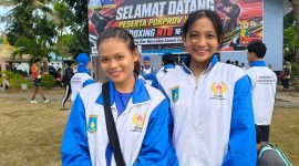 Potret kebahagiaan dua atlet kick boxing andalan Lombok Barat, Ida Lindawati dan Anjani Ramadina, yang sukses mempersembahkan medali Emas saat berpose di depan venue Porprov NTB 2026.(Foto: Istimewa)