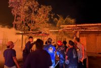 Petugas pemadam kebakaran, personel kepolisian, dan warga berkumpul di lokasi kebakaran untuk memadamkan api yang melanda permukiman Desa Sade, Kabupaten Lombok Tengah, Sabtu malam (22/08/2026).(Foto: Istimewa)