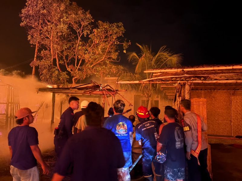 Petugas pemadam kebakaran, personel kepolisian, dan warga berkumpul di lokasi kebakaran untuk memadamkan api yang melanda permukiman Desa Sade, Kabupaten Lombok Tengah, Sabtu malam (22/08/2026).(Foto: Istimewa)