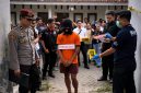 Tersangka pembunuhan mahasiswi Unram, HP (18), mengikuti proses rekonstruksi 44 adegan di TKP, didampingi personel Polresta Mataram dan tim identifikasi INAFIS yang digelar di kawasan Gomong, Kota Mataram.